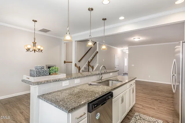 a kitchen with a sink a faucet and chairs