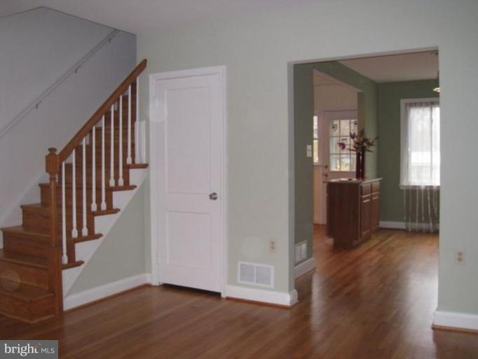 230 Riverthorn Road Middle River, MD 21220 - Photo 5 of 27 a view of a hallway with wooden floor and stairs