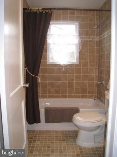230 Riverthorn Road Middle River, MD 21220 - Photo 8 of 27 a bathroom with a toilet a sink and bathtub
