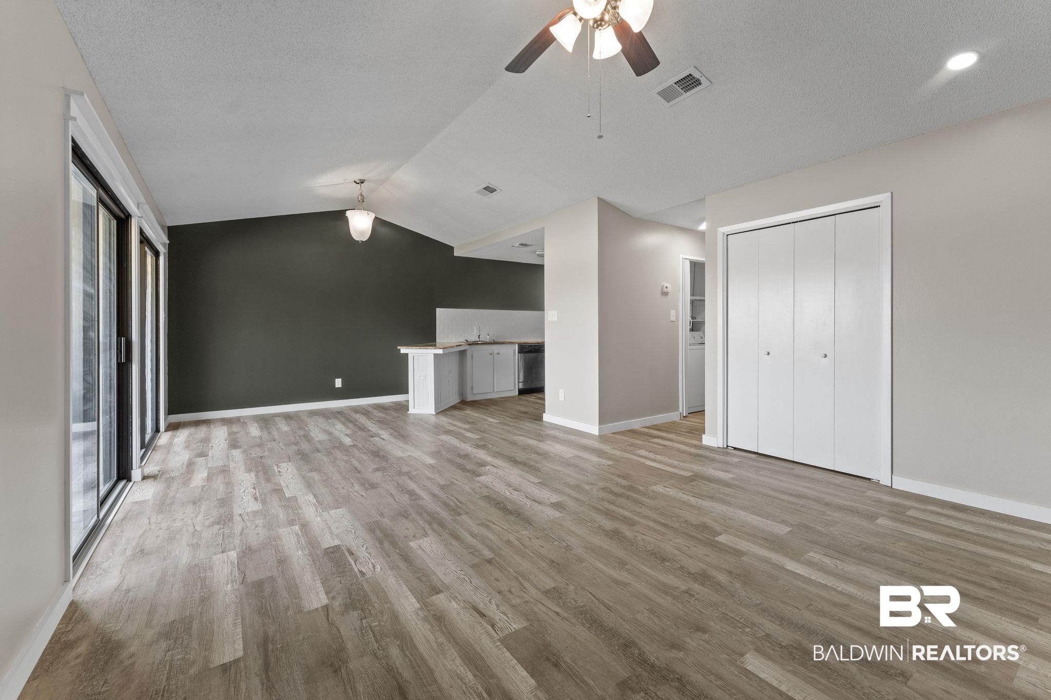 128 West Satsuma Avenue, Unit 128 Foley, AL 36535 - Photo 6 of 41 Unfurnished living room with a ceiling fan and light wood-type flooring