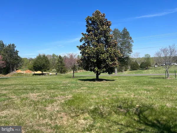 a view of field with trees in the background