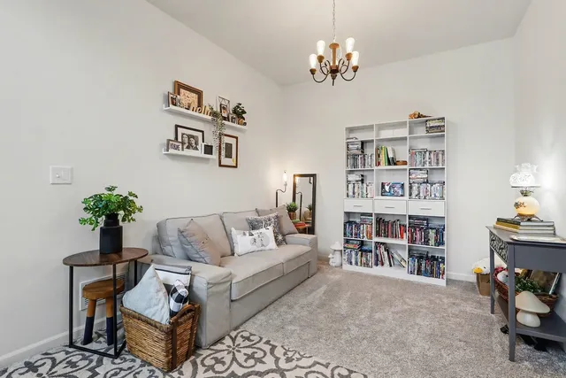a living room with furniture and a bookshelf