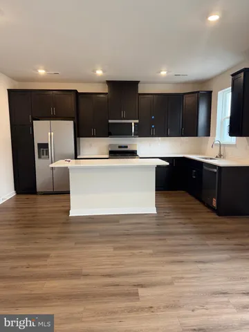a view of kitchen with stainless steel appliances granite countertop a sink and a stove