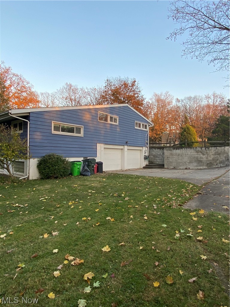 19801 Upper Terrace Road Euclid, OH 44117 - Photo 4 of 22 Rear view of house with a yard and a garage