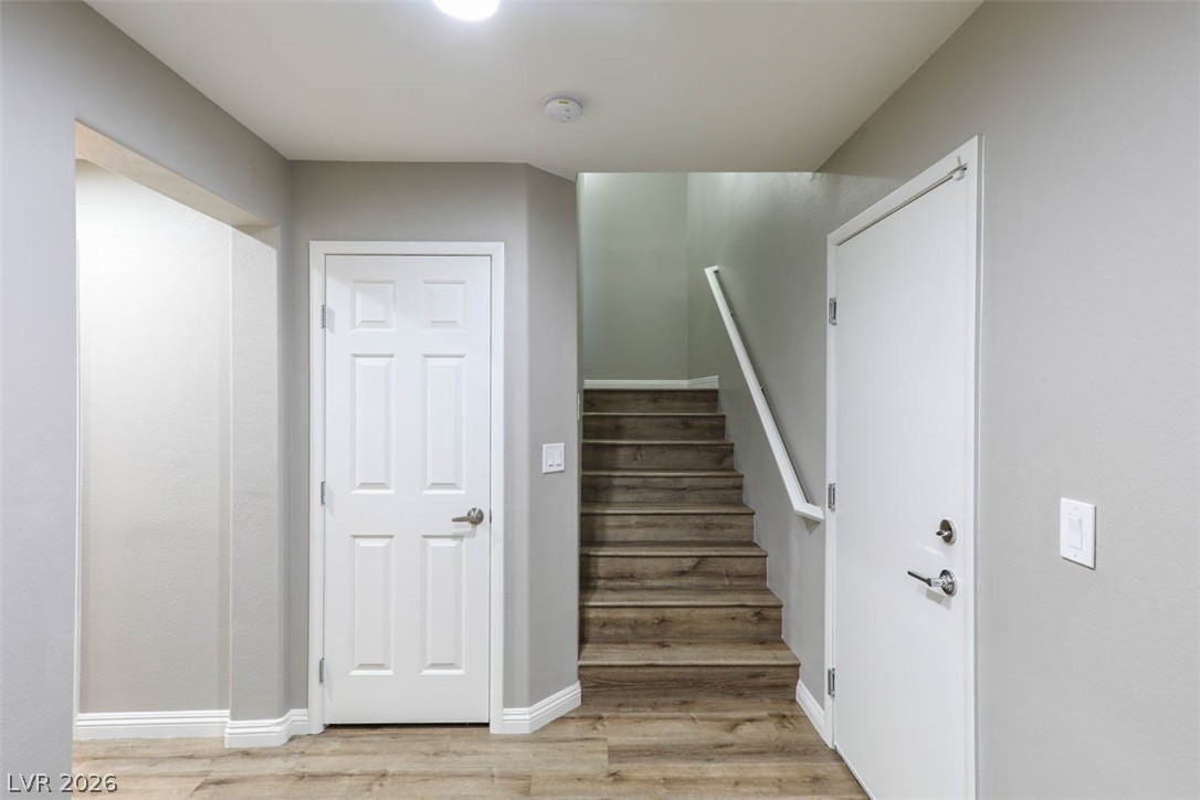 9940 Sable Point Street Las Vegas, NV 89178 - Photo 9 of 40 Staircase with wood finished floors and baseboards