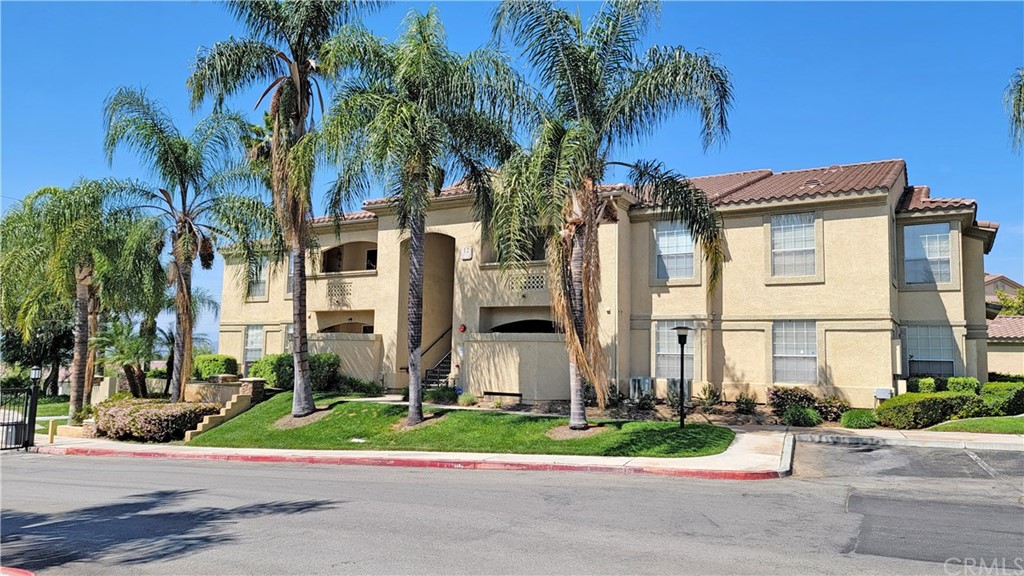 a front view of multiple houses with yard