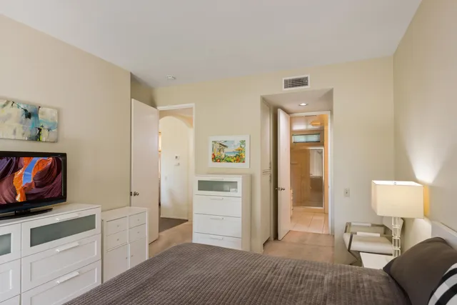 a bedroom with furniture and a flat screen tv
