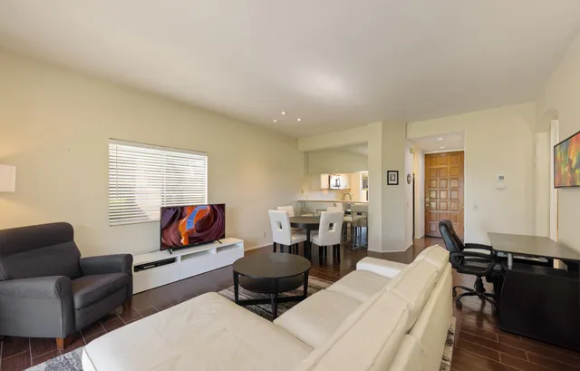 a living room with furniture ceiling fan and a window