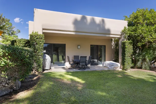 a front view of house with outdoor seating space and garden