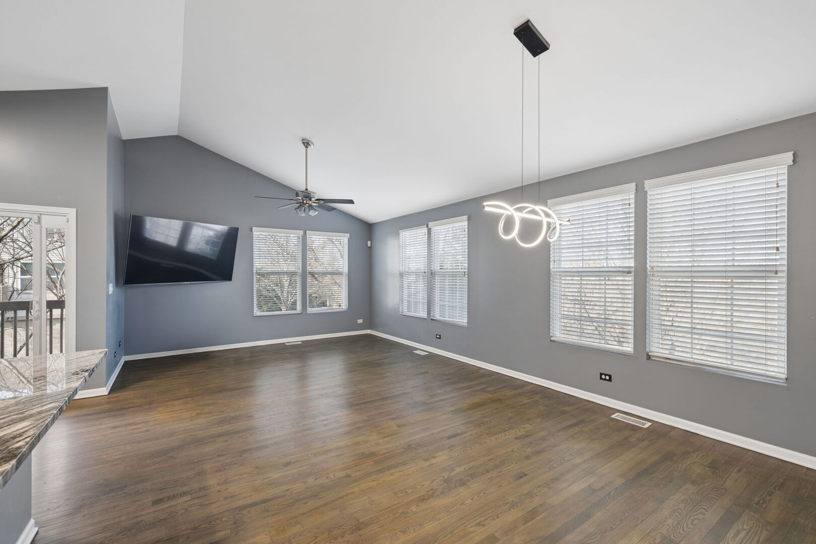 460 Valentine Way Oswego, IL 60543 - Photo 5 of 23 a view of an empty room with a window and wooden floor