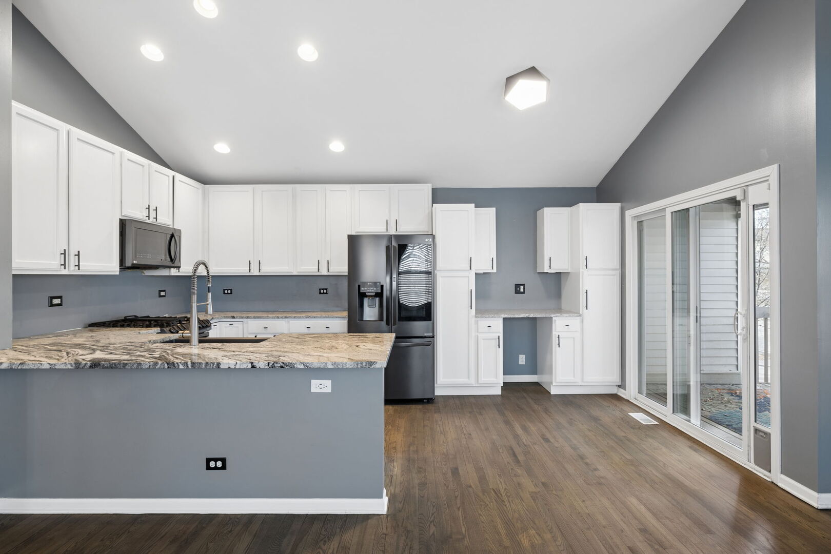 460 Valentine Way Oswego, IL 60543 - Photo 8 of 23 a kitchen with stainless steel appliances granite countertop a refrigerator a sink dishwasher a stove and white countertops with wooden floor
