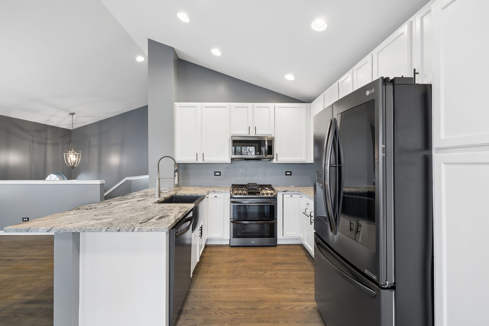 460 Valentine Way Oswego, IL 60543 - Photo 9 of 23 a kitchen with stainless steel appliances granite countertop a refrigerator a stove a sink and a microwave