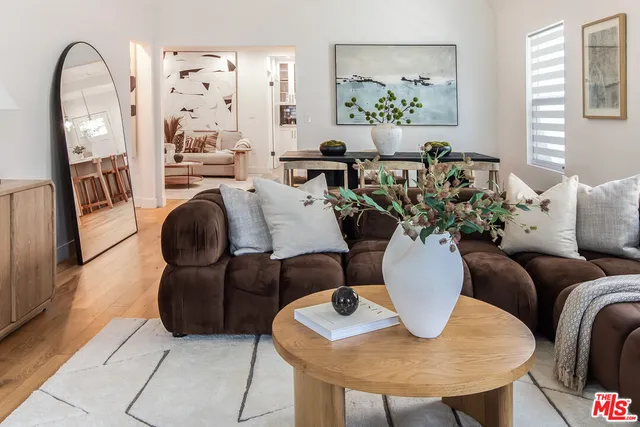 a living room with furniture flowerpot and window