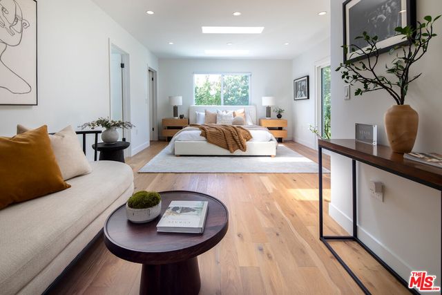 a living room with furniture a rug and a large window