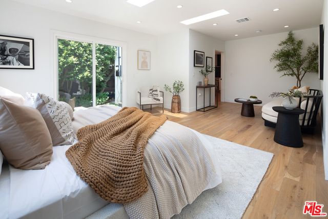 a bedroom with bed and balcony
