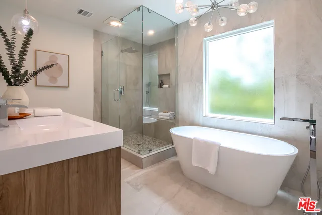 a spacious bathroom with a bathtub and shower