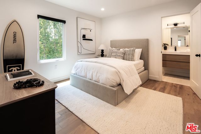 a bedroom with a bed and a tv