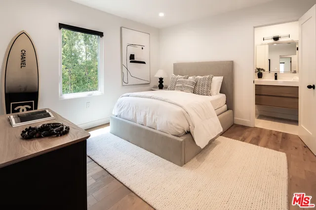 a bedroom with a bed and a tv