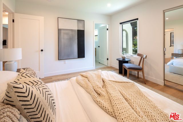 a bedroom with a bed and a chair