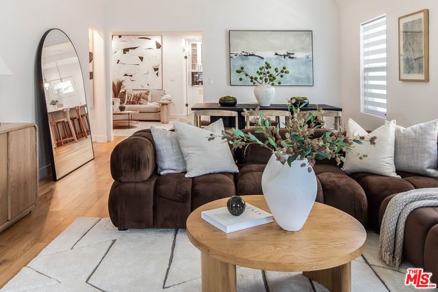 a living room with furniture flowerpot and window