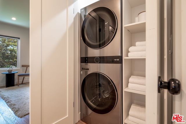 a view of a bedroom with washer and dryer