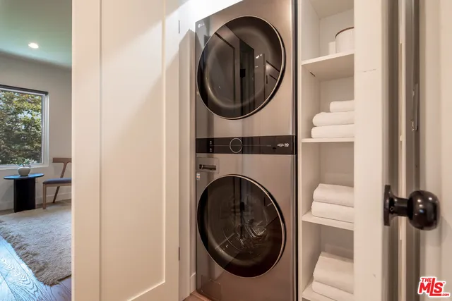 a view of a bedroom with washer and dryer