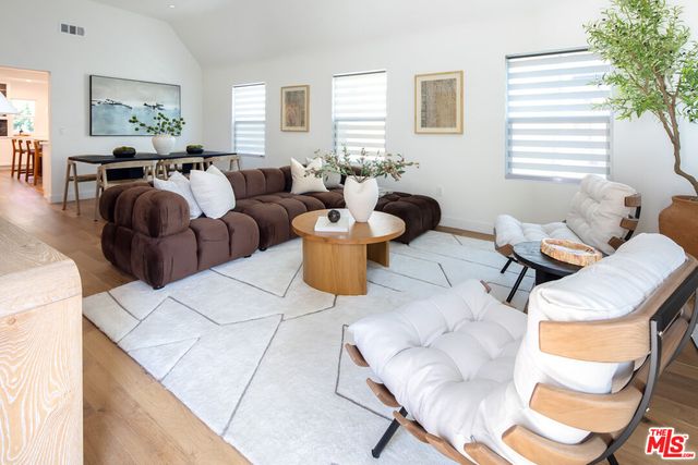 a living room with furniture a window and a table