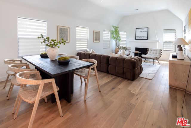 a living room with furniture dining table and a wooden floor
