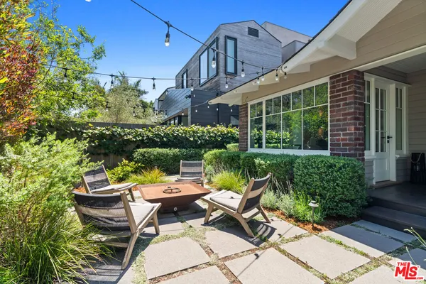 a view of a patio with table and chairs and potted plants