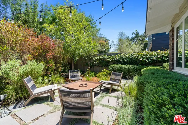 a view of a backyard with sitting area