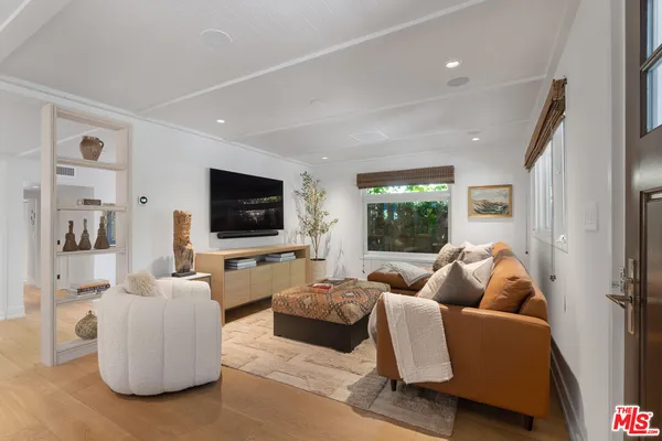 a living room with furniture fireplace and potted plants
