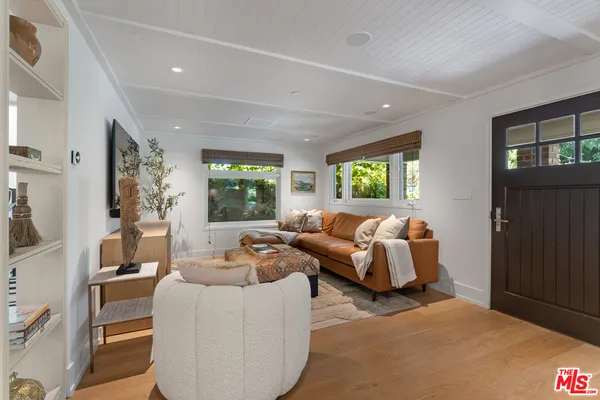 a living room with furniture a fireplace and a potted plant
