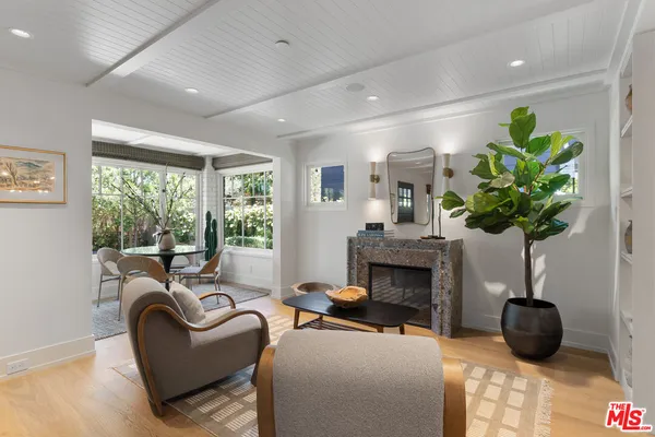 a dining room with furniture wooden floor and a potted plant