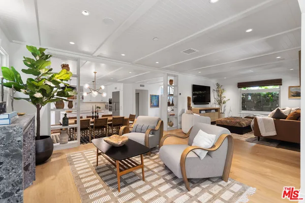a living room with fireplace furniture and a wooden floor