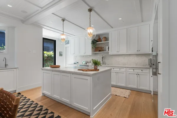 a kitchen with refrigerator and cabinets