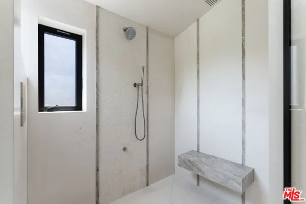 a bathroom with a granite countertop toilet sink and mirror