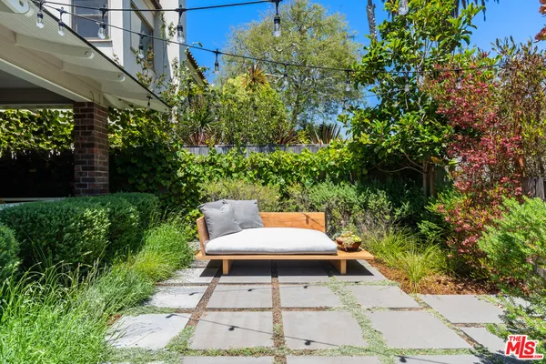 a view of a patio with table and chairs and potted plants
