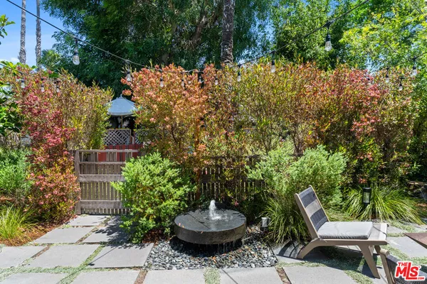a backyard of a house with lots of green space and garden