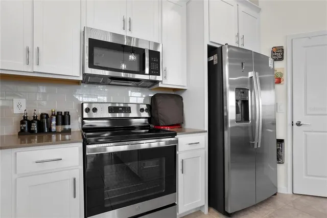 a kitchen with stainless steel appliances a stove a microwave and cabinets