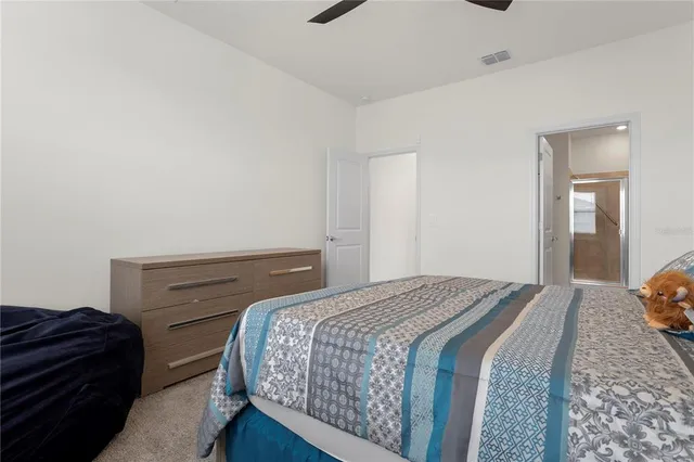 a bedroom with a bed and a dresser