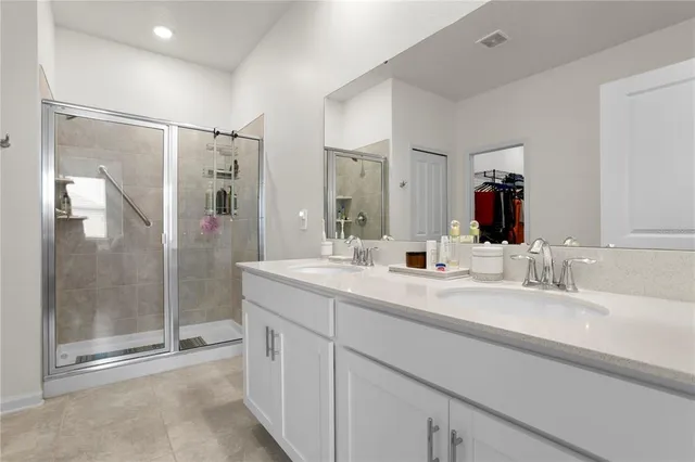 a bathroom with a shower sink and mirror
