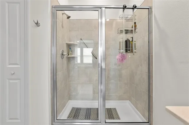 a bathroom with a glass shower door
