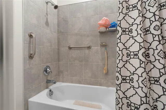 a bathroom with a bathtub and shower