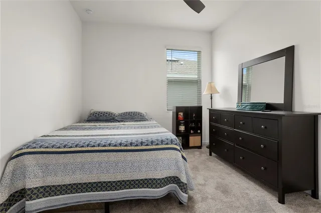 a bedroom with a bed and a mirror