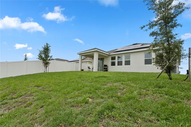 a view of a house with a backyard