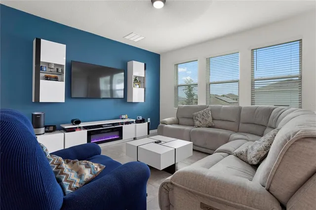 a living room with furniture wooden floor and a window