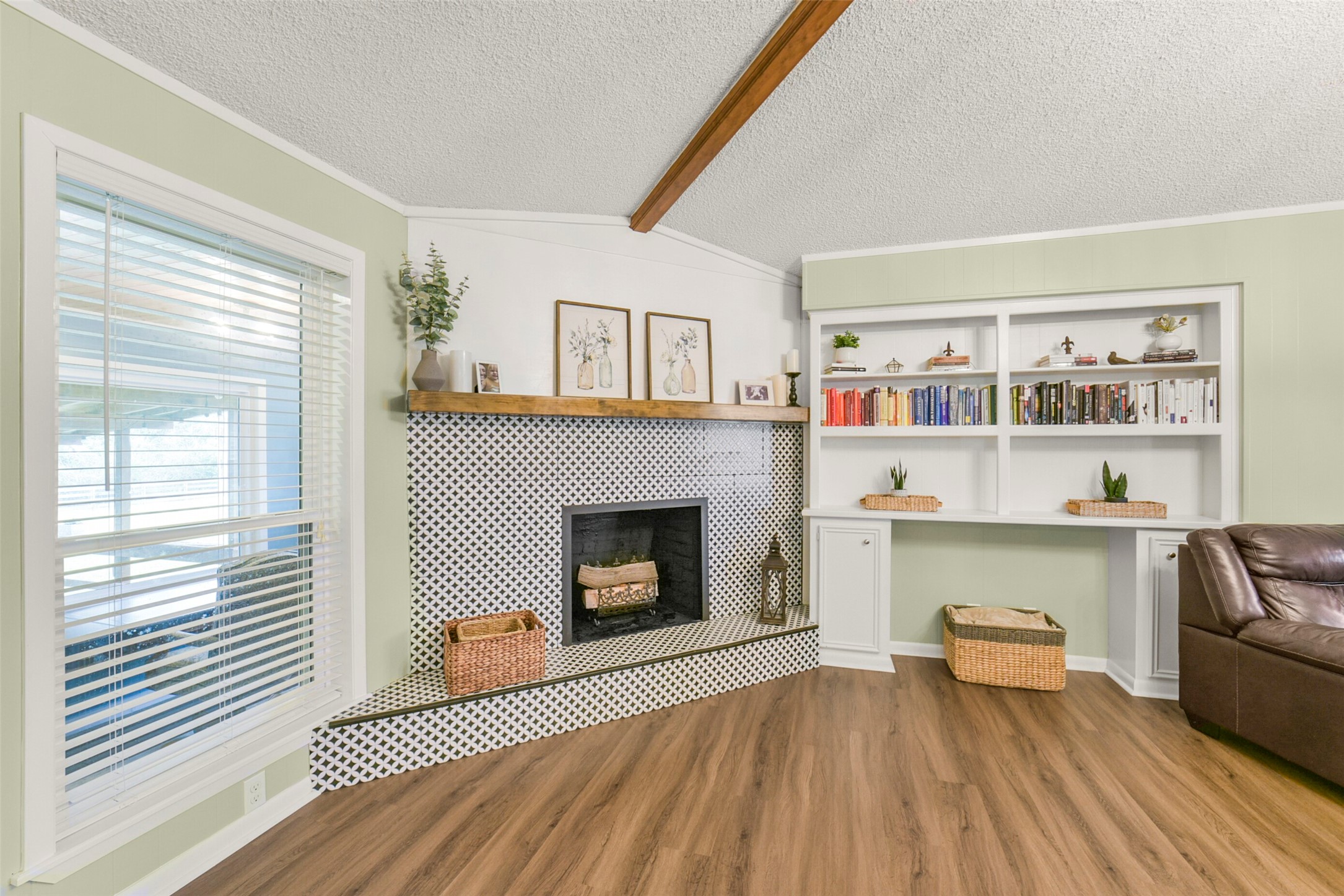10313 South Williams Road Conroe, TX 77303 - Photo 9 of 48 Wood burning fire place with upgraded tile and mantel. Luxury vinyl plank flooring is durable and beautiful!