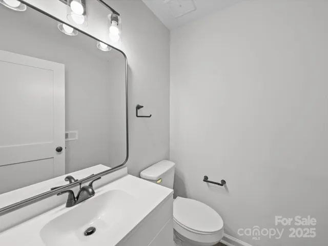 a view of a hallway with wooden floor and entryway