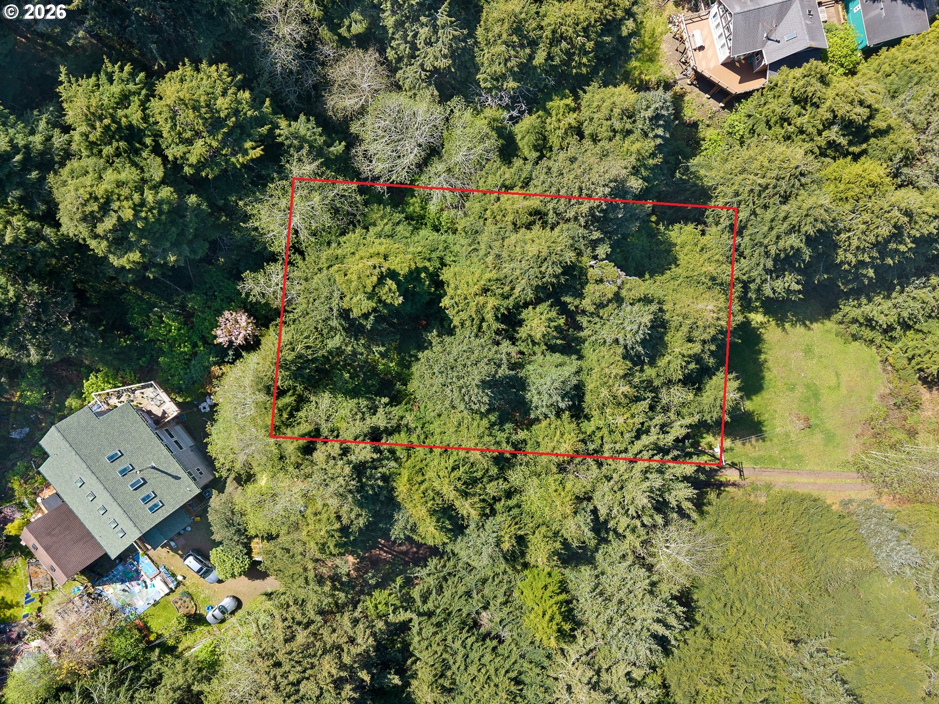 7th Street Northwest, Unit 11300 Tillamook, OR 97141 - Photo 5 of 13 an aerial view of a residential houses with yard
