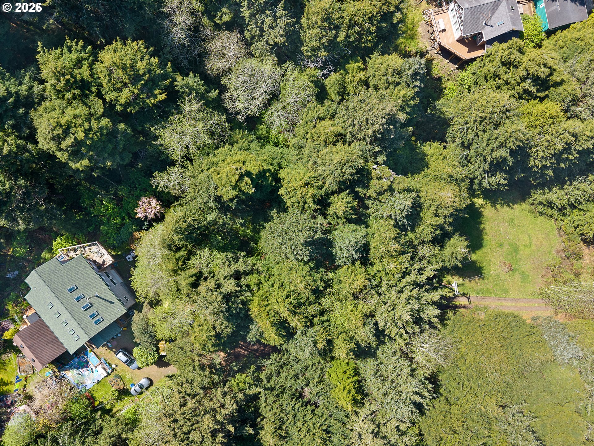 7th Street Northwest, Unit 11300 Tillamook, OR 97141 - Photo 6 of 13 an aerial view of a house with a yard